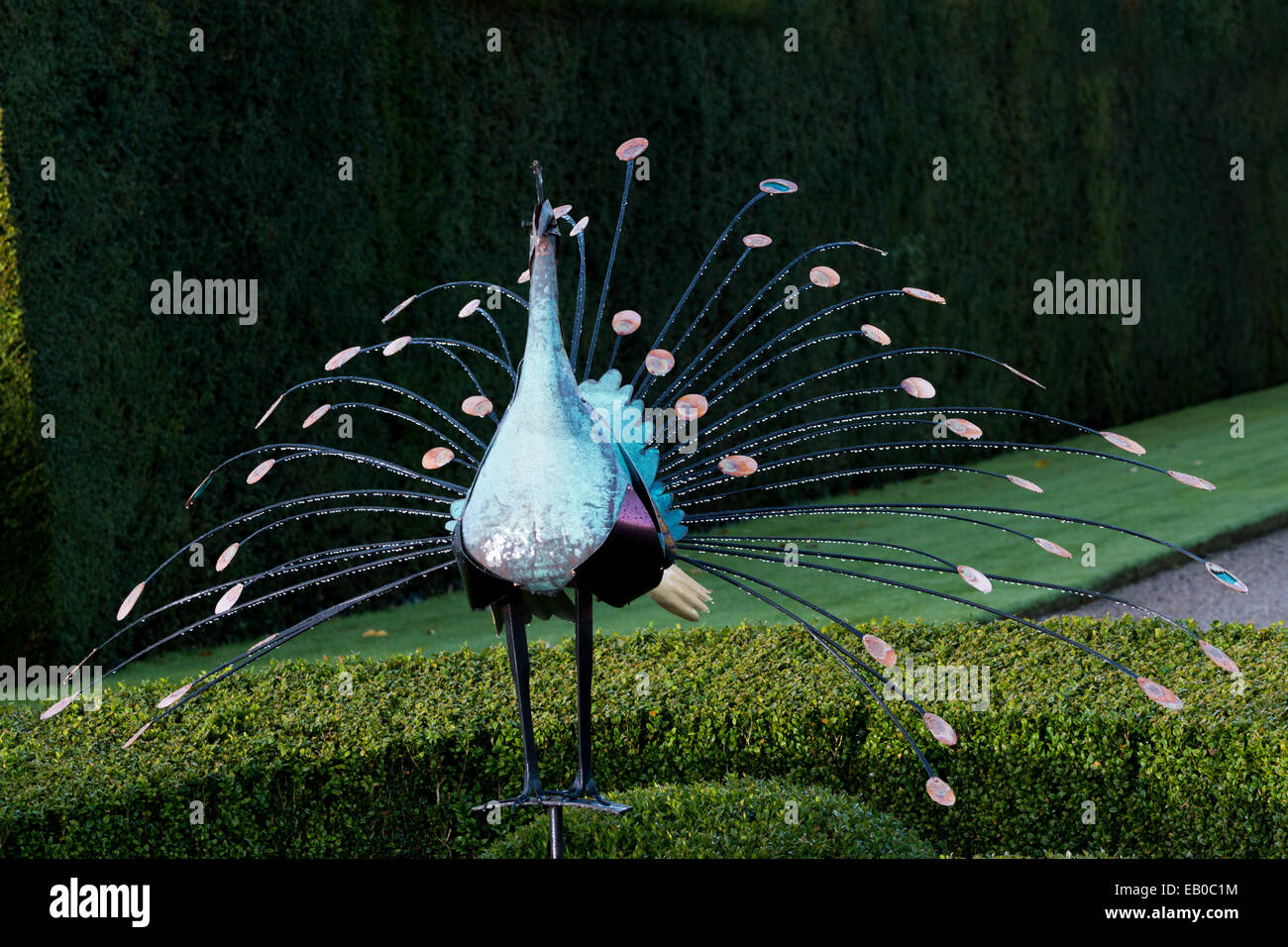 scenes from a garden including frosted sculpture and flowers Stock Photo