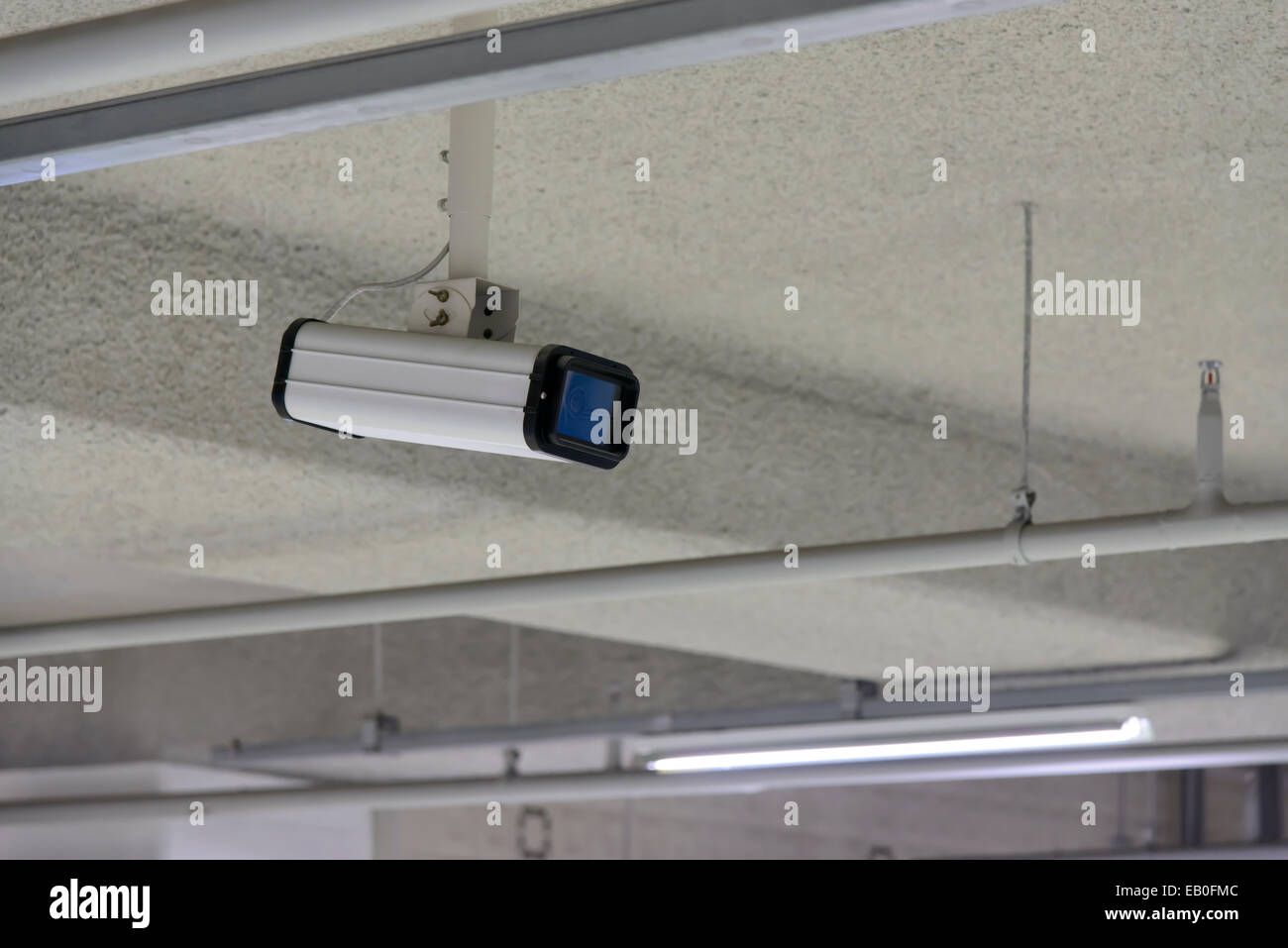 cctv camera on the ceiling in parking lot Stock Photo