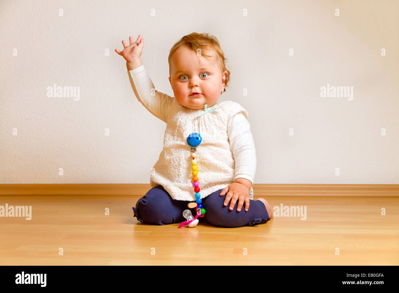 Happy baby waving at home Stock Photo Alamy