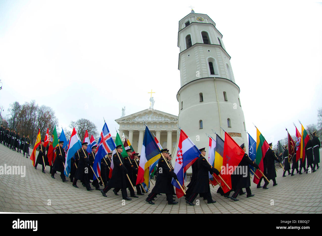 Vilnius, Lithuania. 23rd Nov, 2014. Guard of honor carry the flags of NATO member countries on the celebration in Vilnius, Lithuania, on Nov. 23, 2014. Lithuanian armed forces and troops of some NATO member countries held a gala with formation on Sunday to celebrate the Armed Forces Day. Lithuania's first decree on establishing armed forces was approved on Nov. 23, 1918, which became the Armed Forces Day of the Baltic country. © Alfredas Pliadis/Xinhua/Alamy Live News Stock Photo