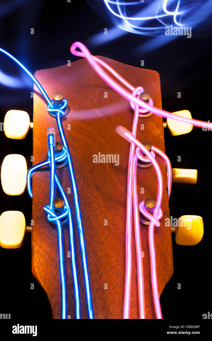 Acoustic guitar with strings removed and substituted with electro luminescent wire Stock Photo