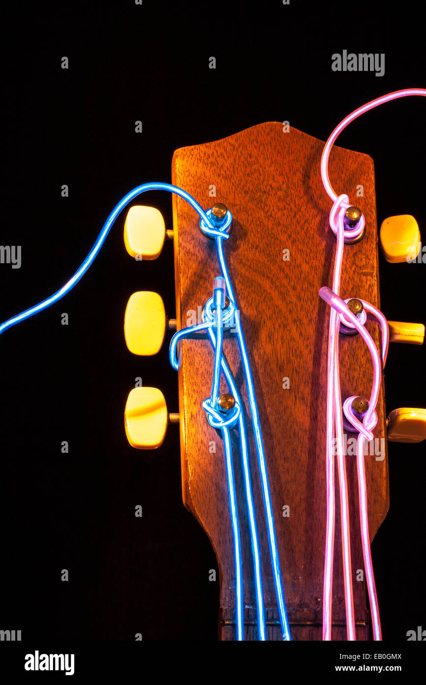 Acoustic guitar with strings removed and substituted with electro luminescent wire Stock Photo