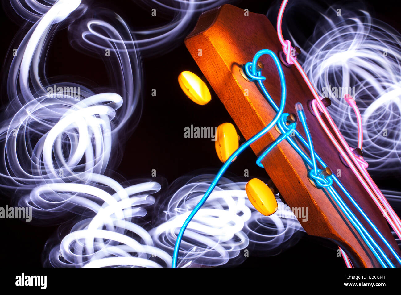 Acoustic guitar with strings removed and substituted with electro luminescent wire Stock Photo