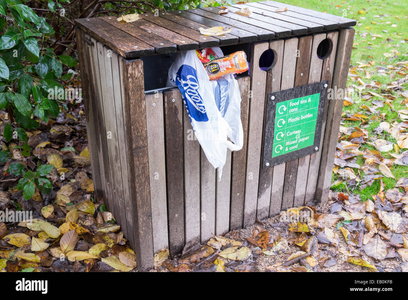 Overflowing wooden recycling bin in park Stock Photo Alamy