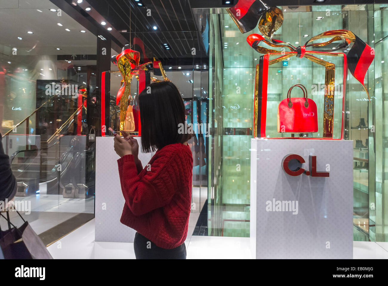 Paris, France, Woman Holiday Shopping, Texting on telephone inside French  Department Store, Galeries Lafayette, Luxury Brand Store Product display;  Louis Vuitton, shopper Using Iphone, haute couture accessories, centre  fashion, clothing store women