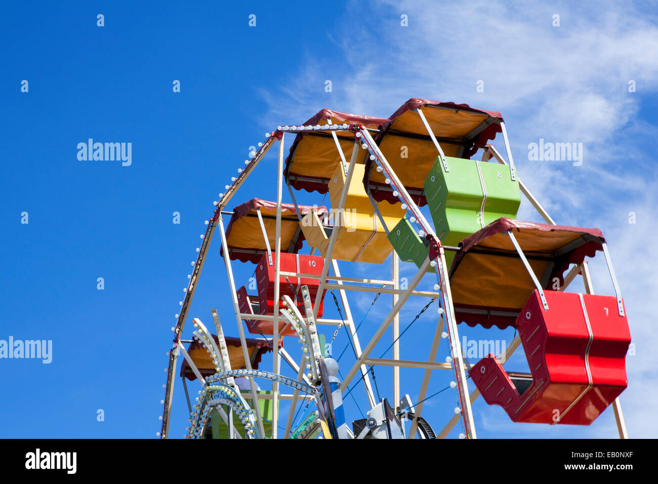 colorful carousel at a fairground against a blue sky Stock Photo