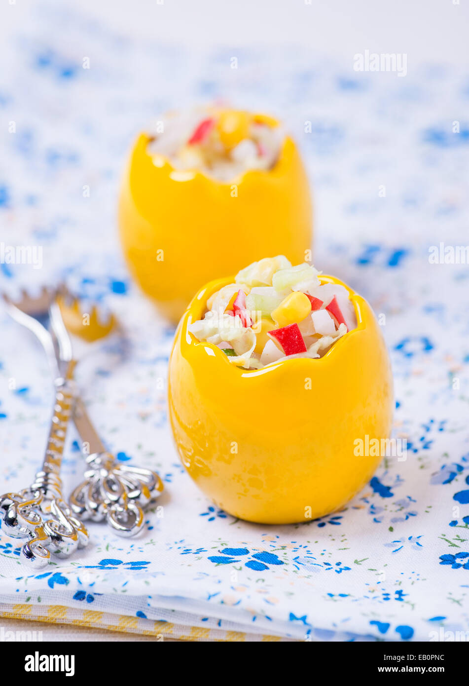 Vegetable salad with corn, cabbage, crab and mayonnaise in egg-shaped bowls, selective focus Stock Photo
