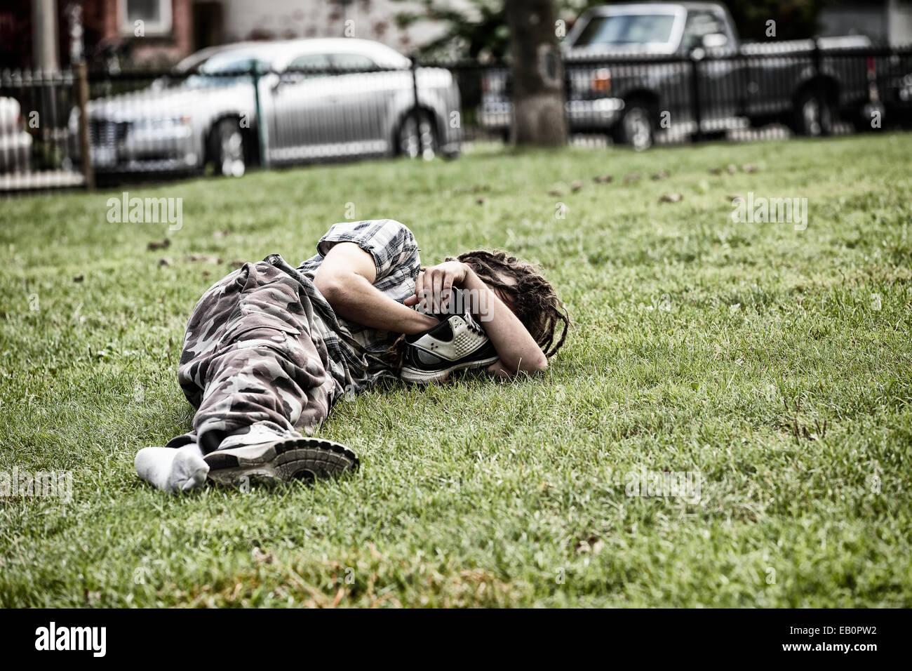 Homeless man sleeping in park, Toronto, Ontario, Canada Stock Photo