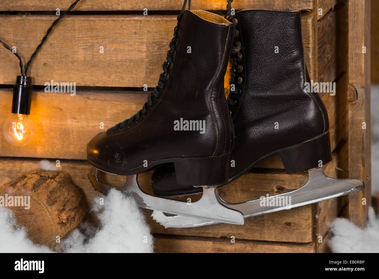 Close up Pair of Black Leather Ice Skates Hanging on the Wooden Wall