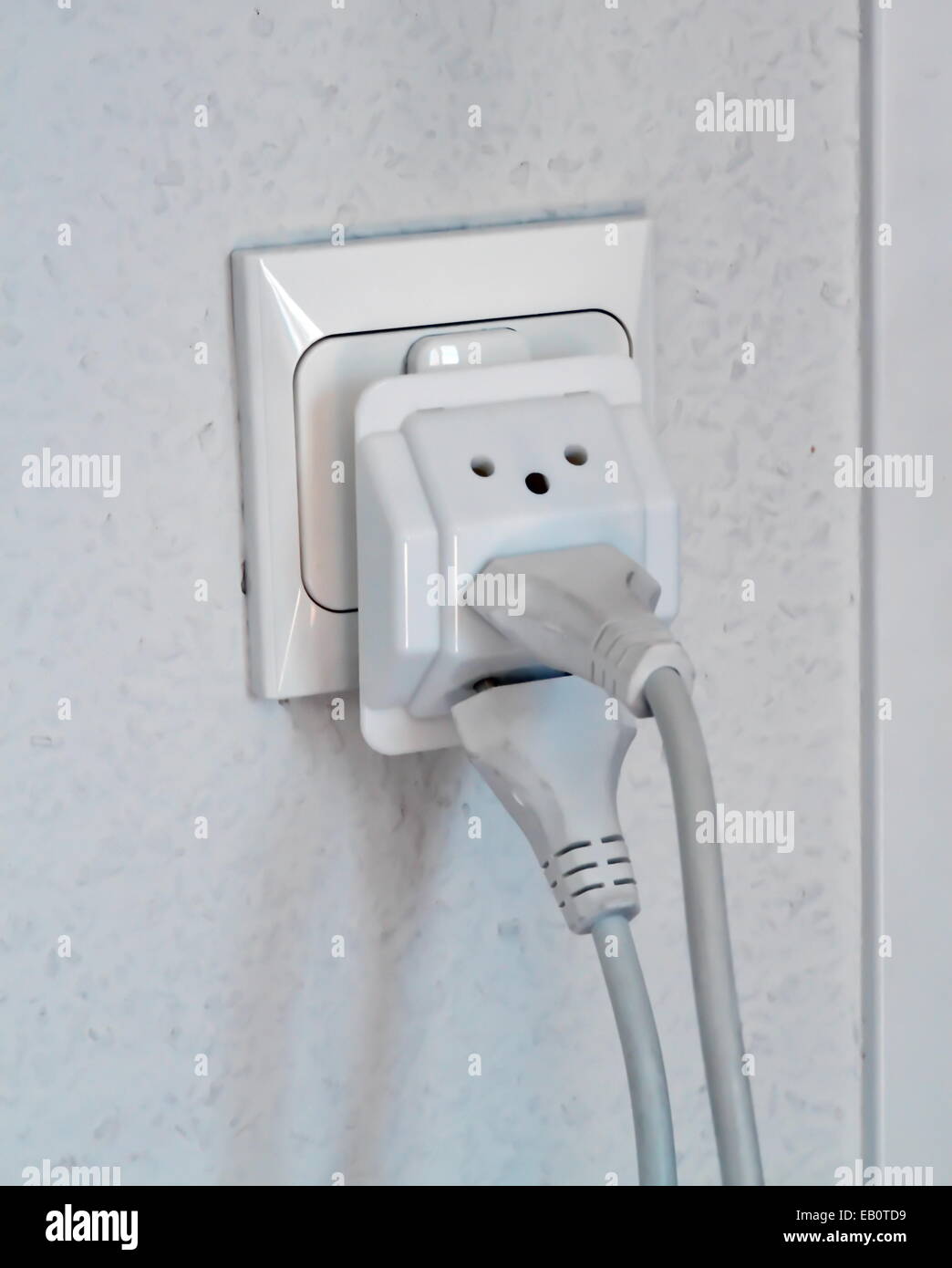 Multiple electrical plugs in wall outlet, Switzerland, Europe Stock Photo