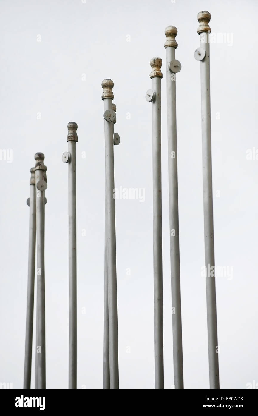Multiple flag poles in a row with no flags Stock Photo