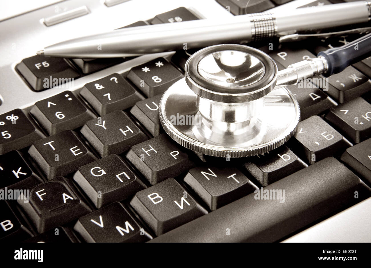 stethoscope and silver pen on computer keyboard Stock Photo - Alamy