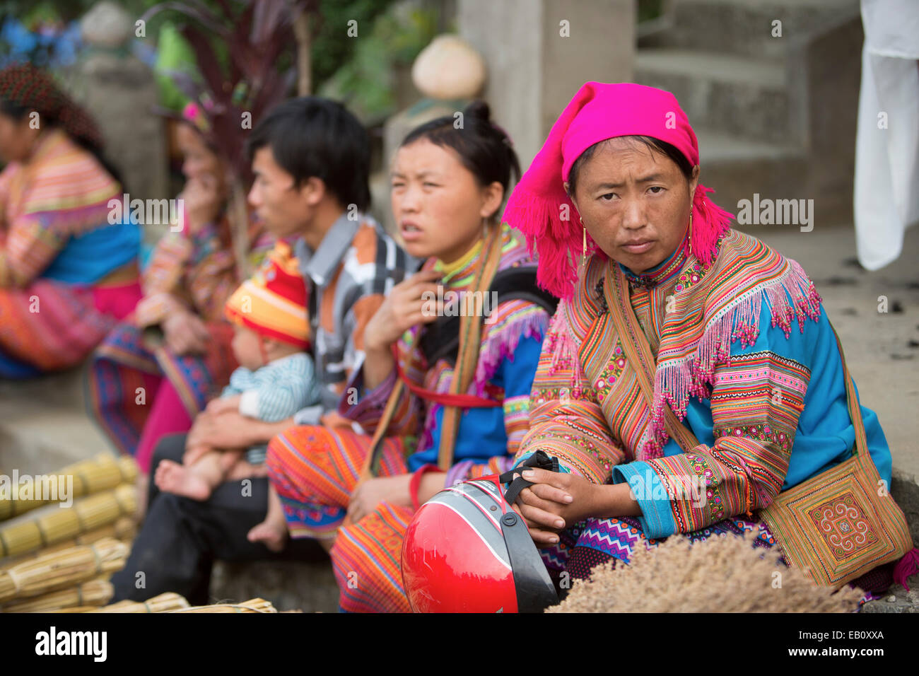 Flower Hmong women selling incense at BacHa market in Vietnam Stock Photo