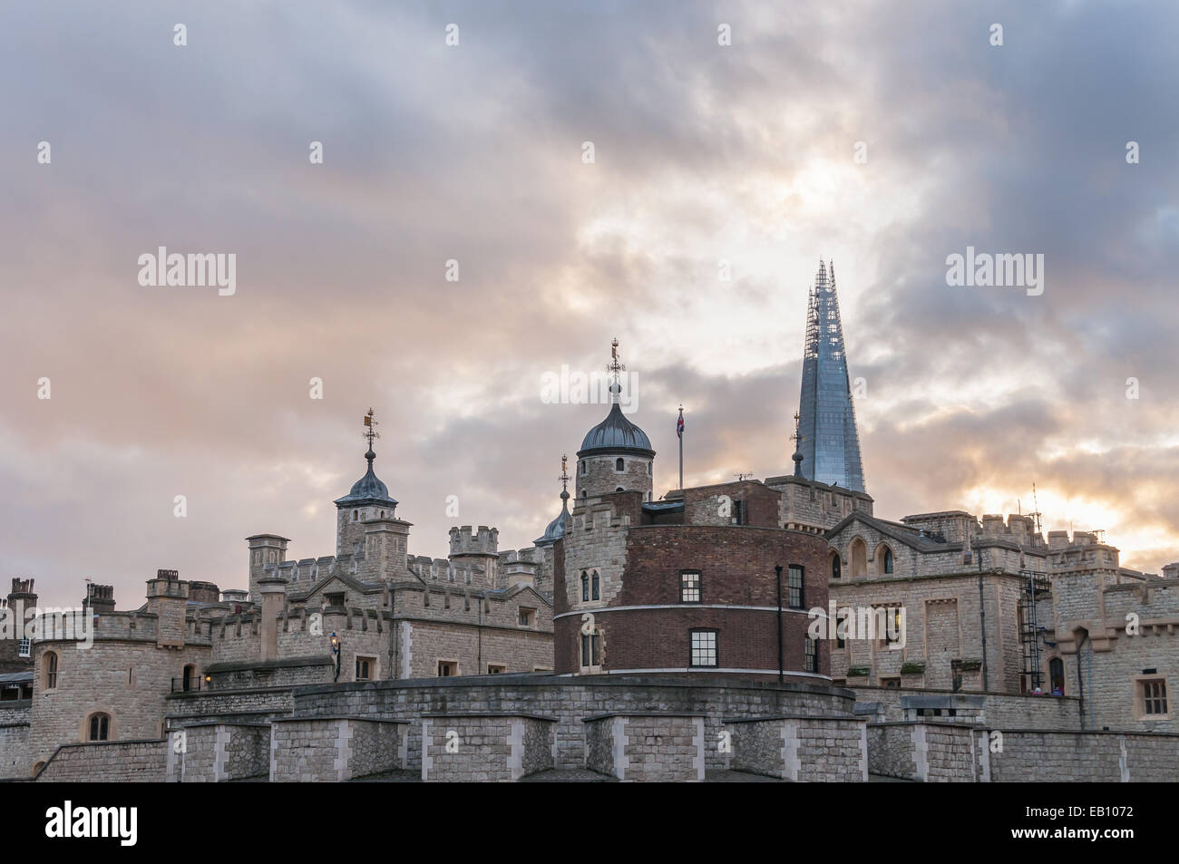 Closeup of Tower of London architecture with The Shard skyscraper in the background at sunset, UK Stock Photo