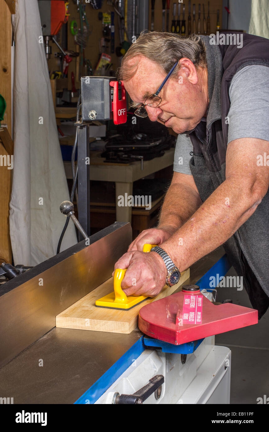 Woodworking using a jointer machine with safe process Stock Photo Alamy