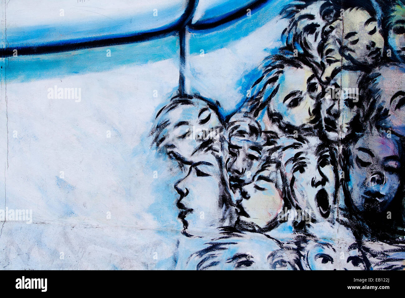 Graffiti tortured faces street art Berlin wall Stock Photo