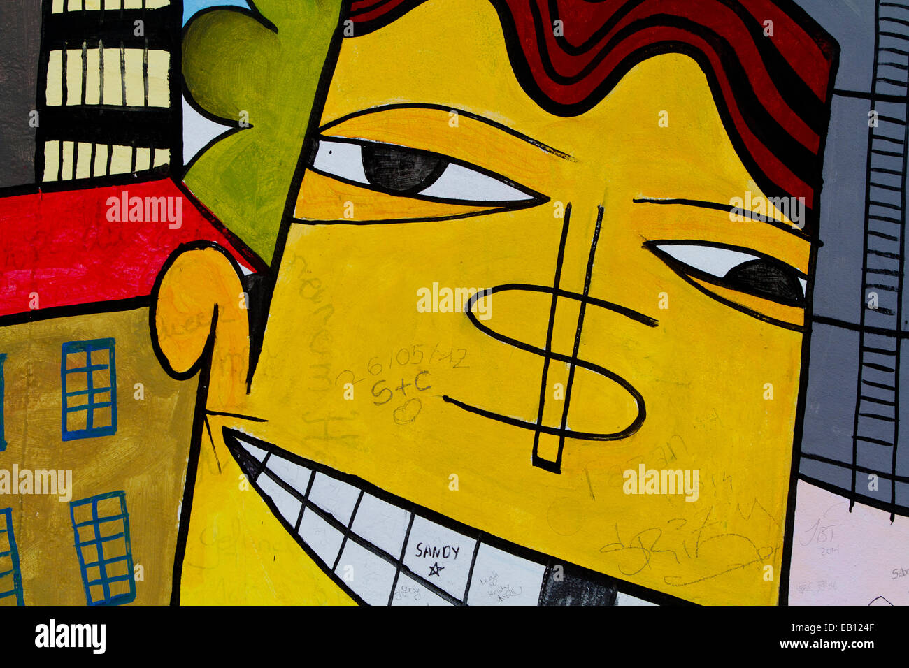 Graffiti cartoon dollar man street art Berlin wall Stock Photo