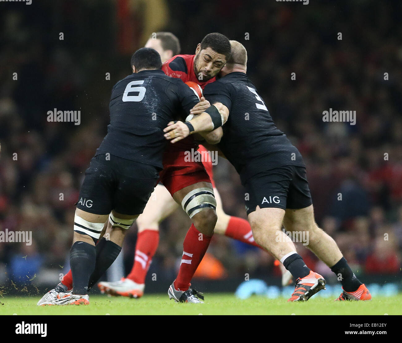 Cardiff, UK. 22nd Nov, 2014. Taulupe Faletau of Wales tackled by Kieran Read and Owen Franks of New Zealand - Autumn Test Series - Wales vs New Zealand - Millennium Stadium - Cardiff - Wales - 22nd November 2014 - Picture Simon Bellis/Sportimage. © csm/Alamy Live News Stock Photo