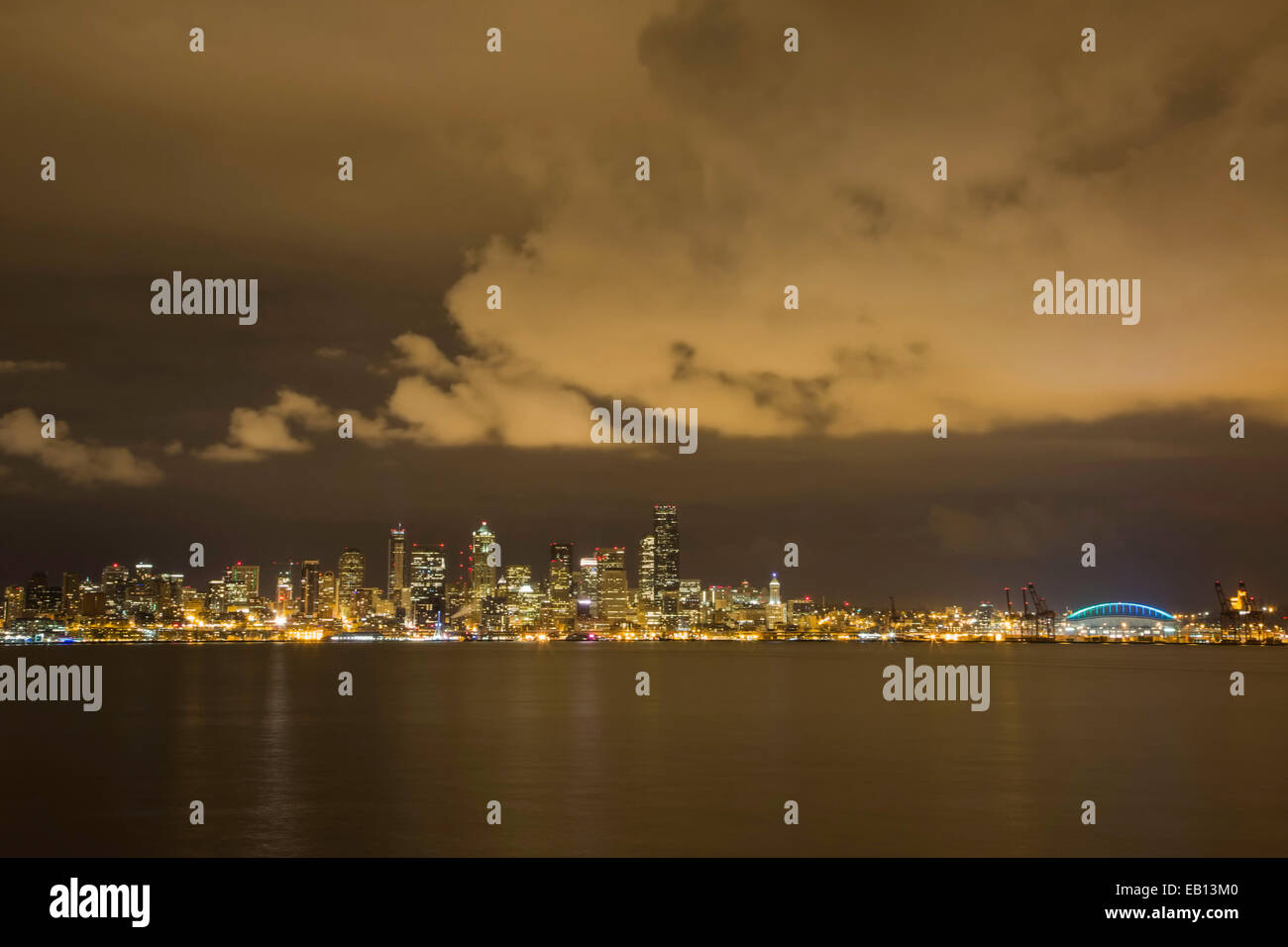 The lovely Seattle skyline at night with clouds leading into and out of ...