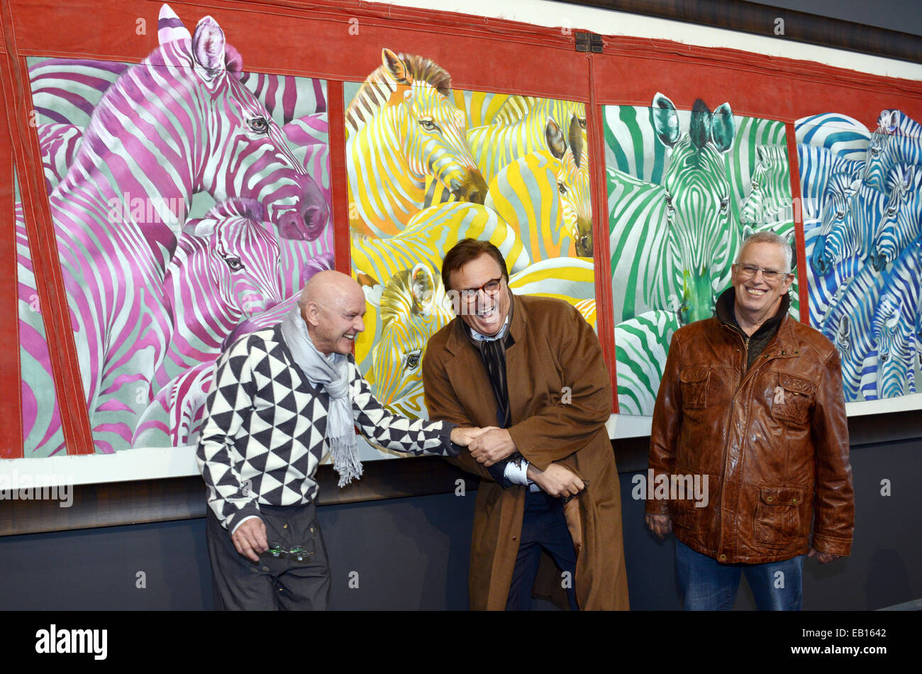 Rust, Germany. 22nd Nov, 2014. Swiss painter and former actor and clown Rolf Knie (L) kids around with the director of Europa Park, Roland Mack (C), and Charlie Chaplin's son, Eugene Chaplin (R) in front of some of his paintings in the exhibition 'Rolf Knie - Circus' in Europa Park in Rust, Germany, 22 November 2014. The exhibition, which showcases his life's work, can be seen until 11 January 2015. Photo: PATRICK SEEGER/dpa/Alamy Live News Stock Photo