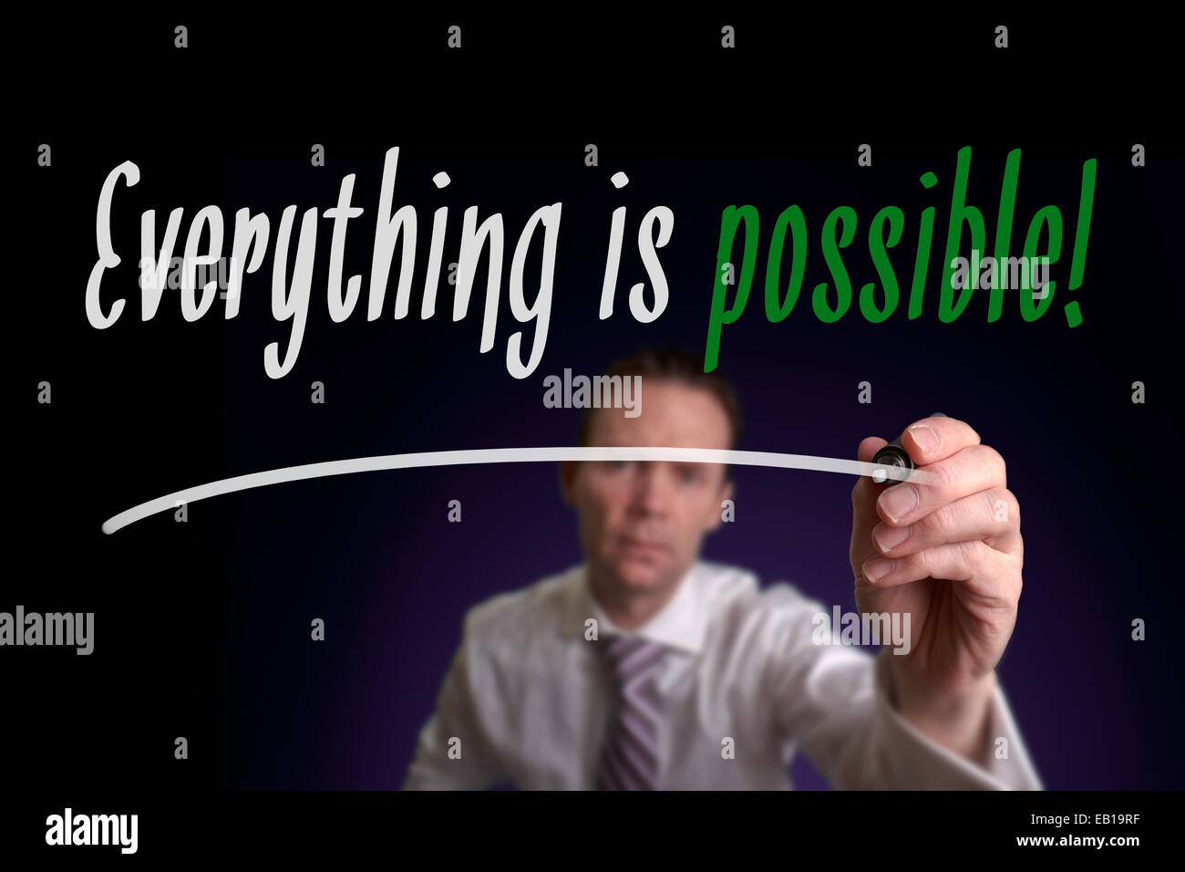 A businessman writing Everything is Possible on a screen. Business Concept. Stock Photo