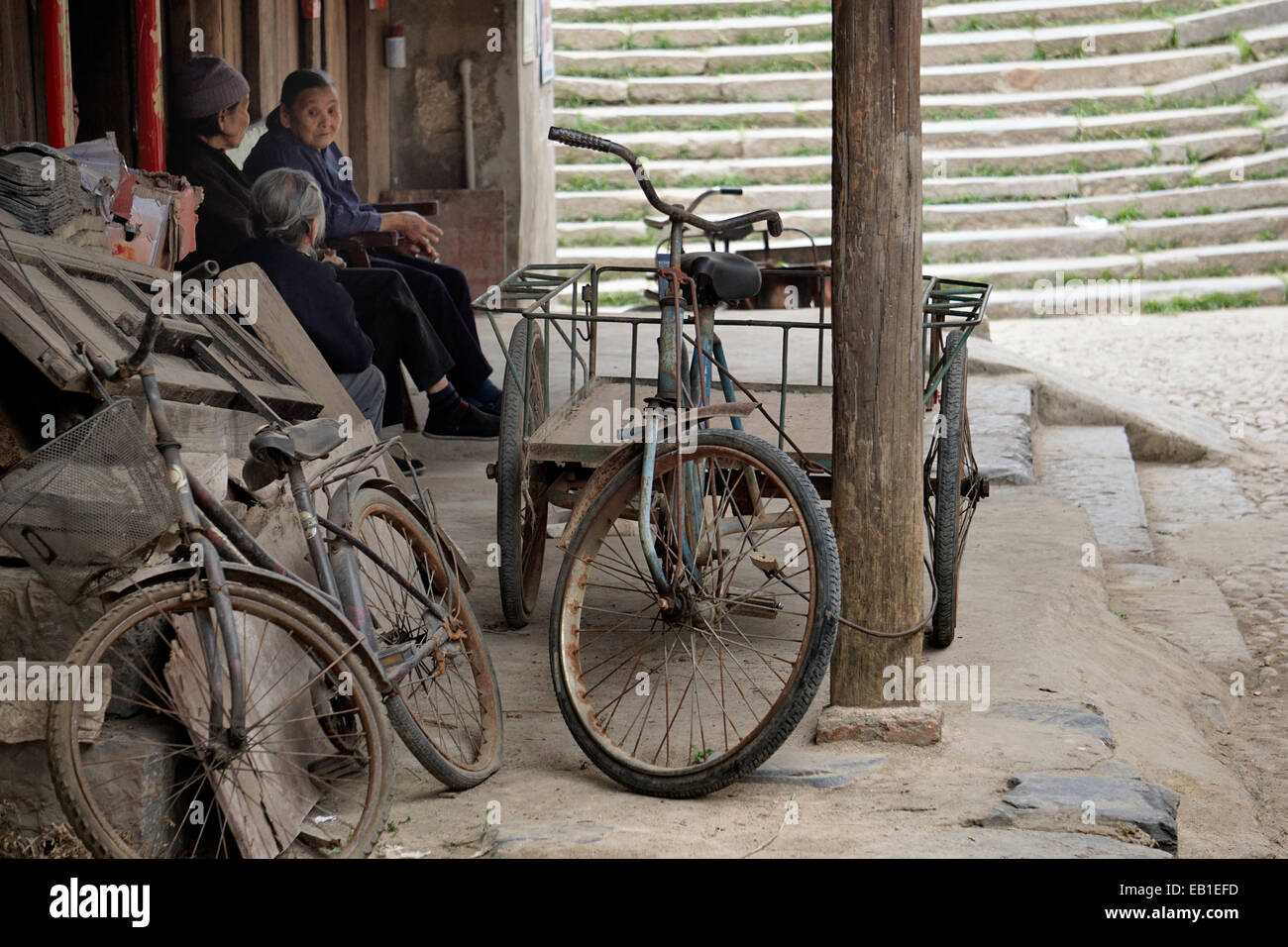 Seniors,resting in the shade and memories of bicycle transportation Stock Photo