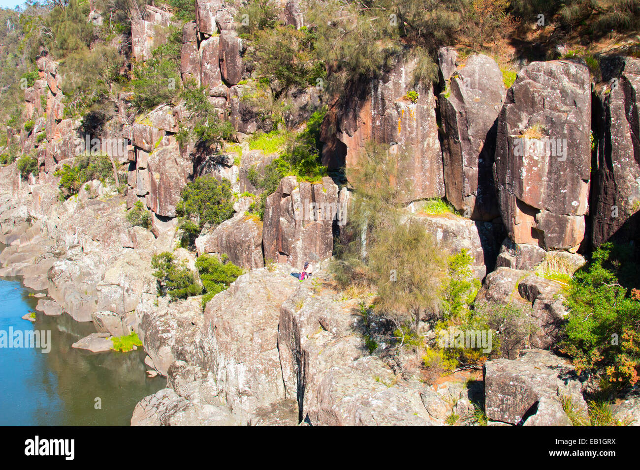man sitting on the rocks in cataract gorge,Launceston,Tasmania Stock Photo