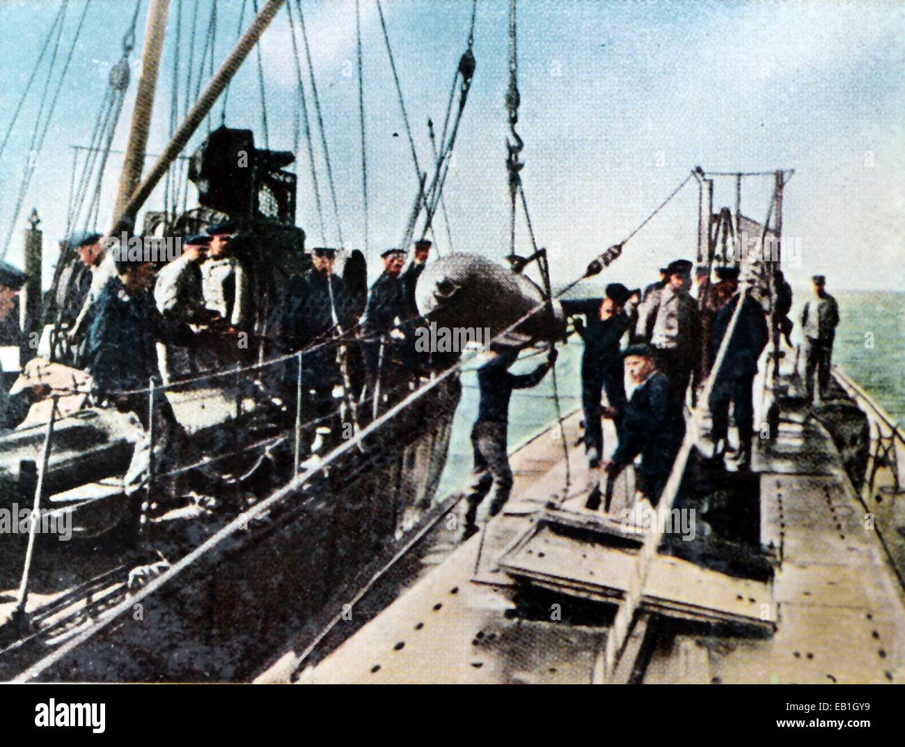 The contemporary colorized German propaganda photo shows a torpedo being loaded onto a Germany submarine, date and location unknown (1914-1918). Photo: Neumann Archive - NO WIRE SERVICE – Stock Photo