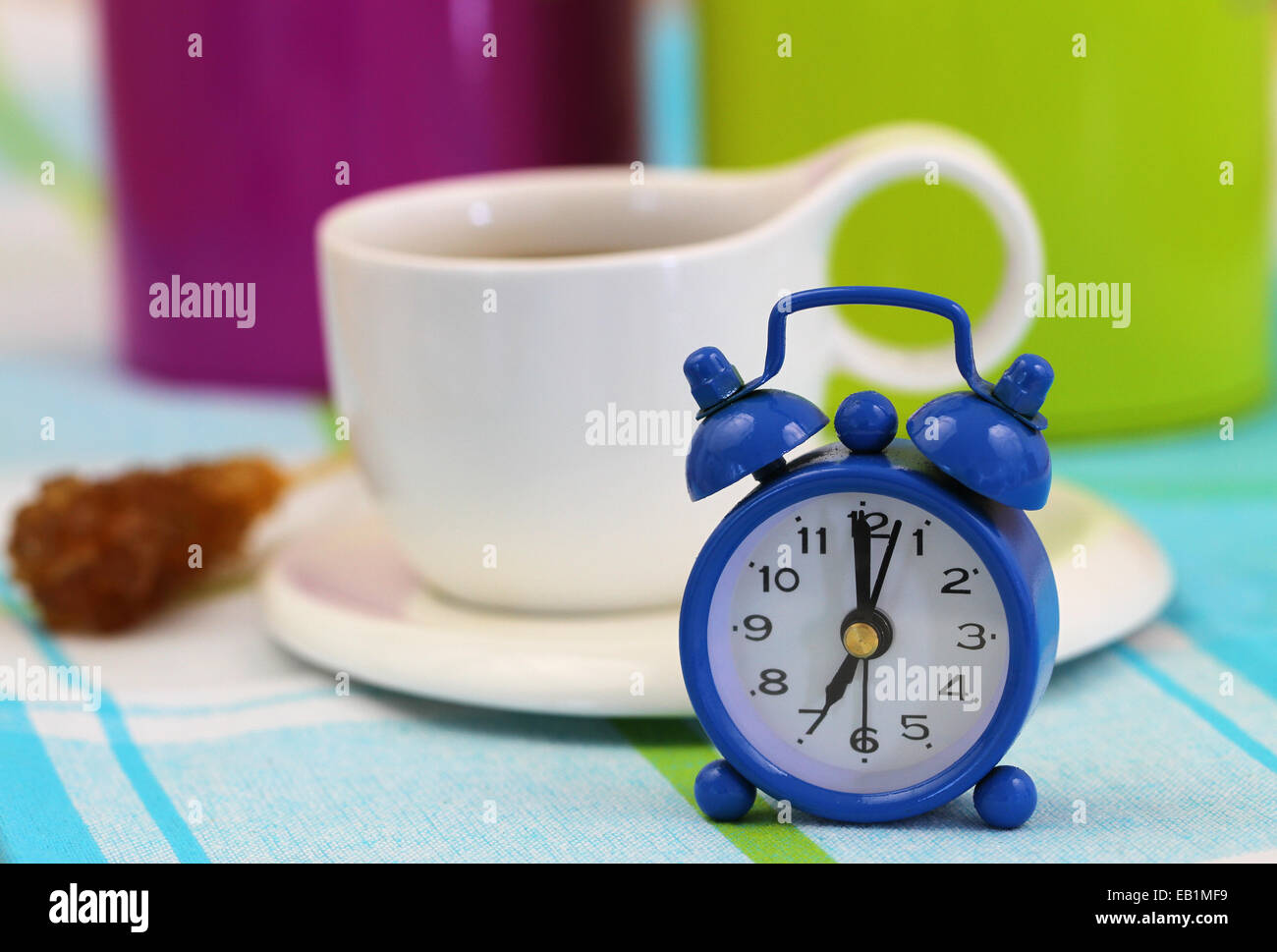Miniature clock showing 7 and cup of coffee Stock Photo