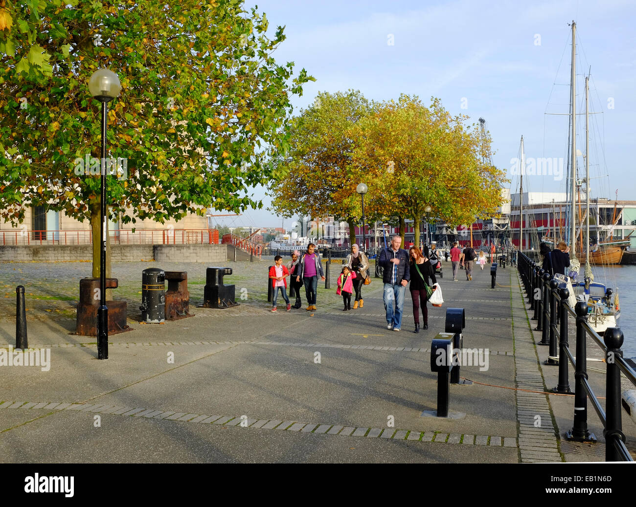 Bristol, England - October 31st, 2014: People walking on Hanover Quay in the Canon's Marsh area of the old docks. Stock Photo
