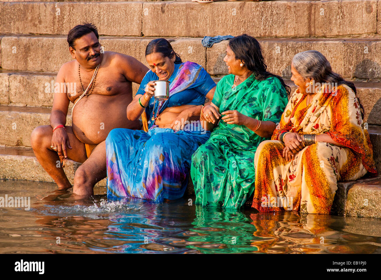 Women bathing in saris hi-res stock photography and images - Alamy