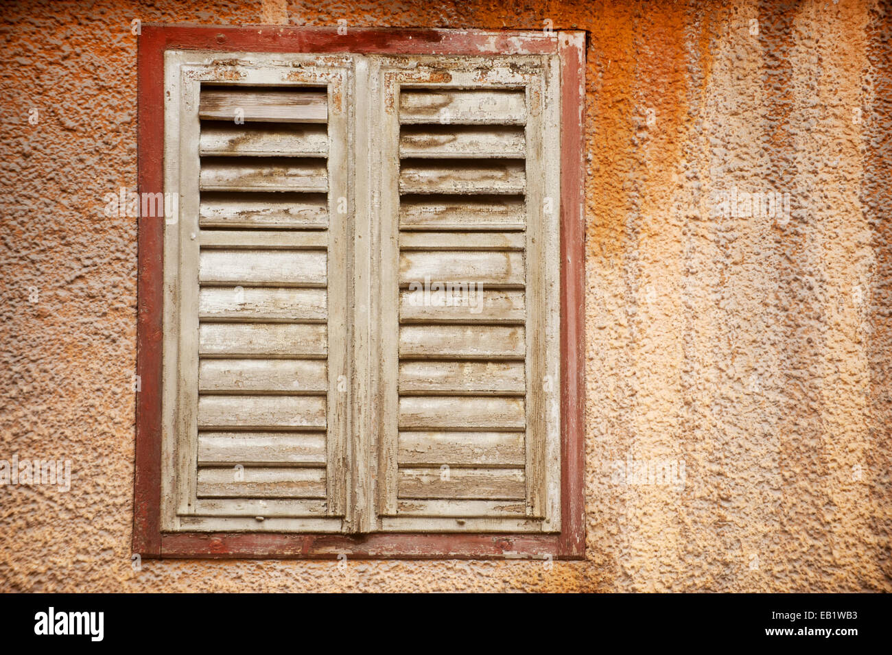 Architecture detail with old and weathered shutters from an abandoned house Stock Photo