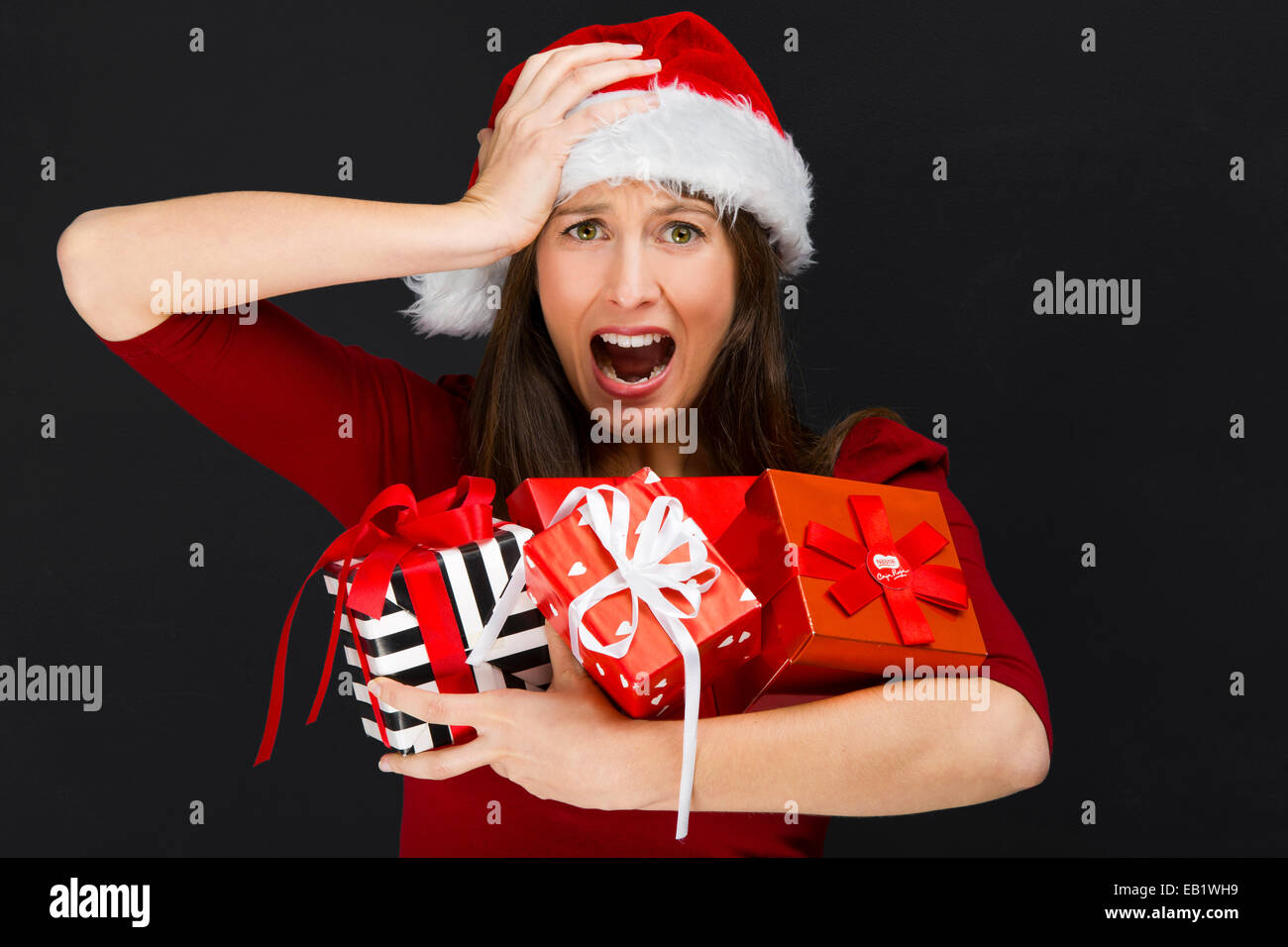 Beautiful young woman holding christmas gifts Stock Photo - Alamy