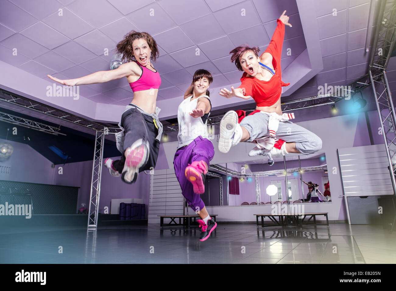 group of  women in sport dress jumping at fitness dance exercise or aerobics Stock Photo