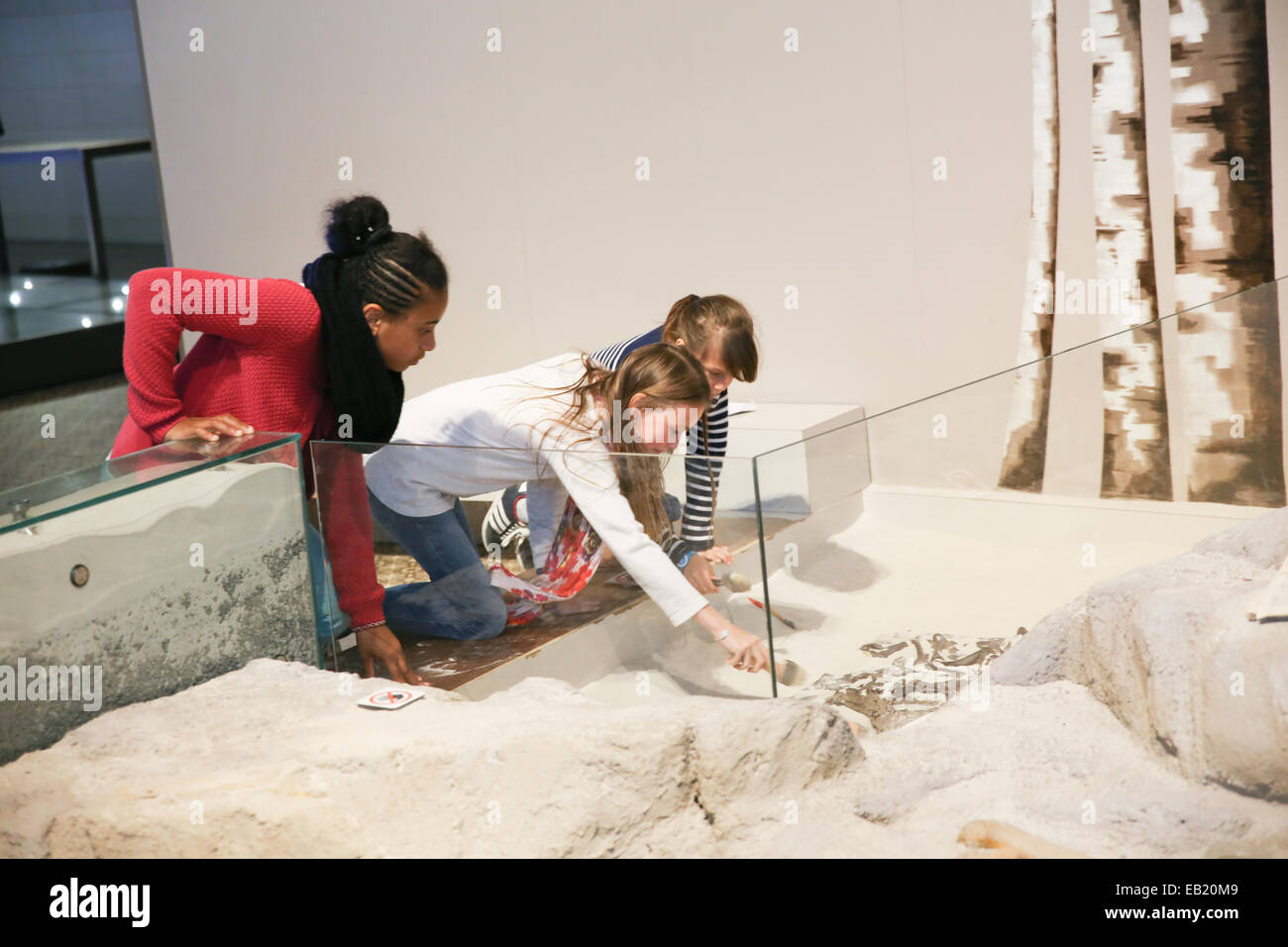 young girls playing white sand inside science museum europe Stock Photo