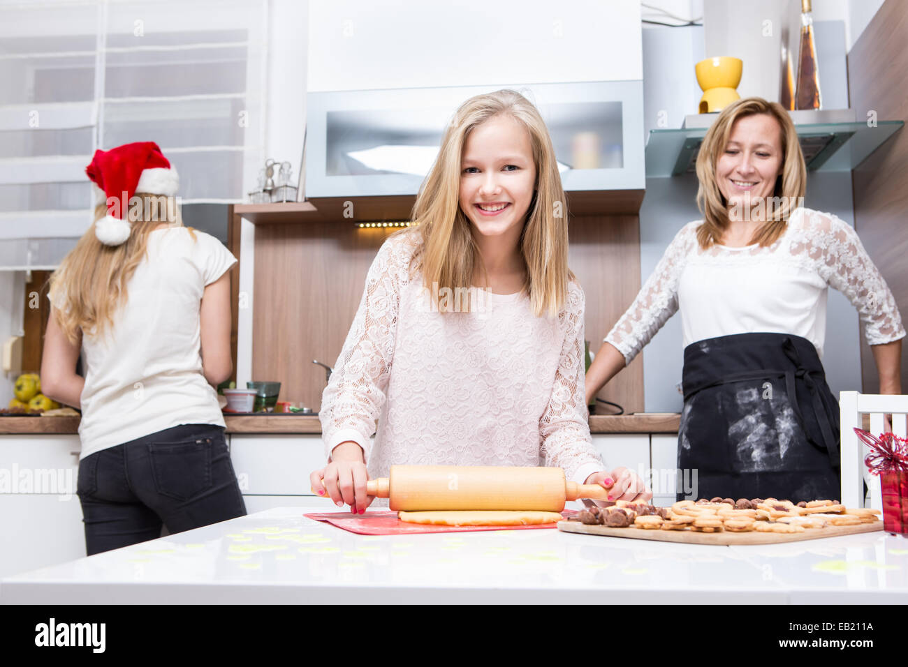 girl making xmas cookies at home with her family Stock Photo