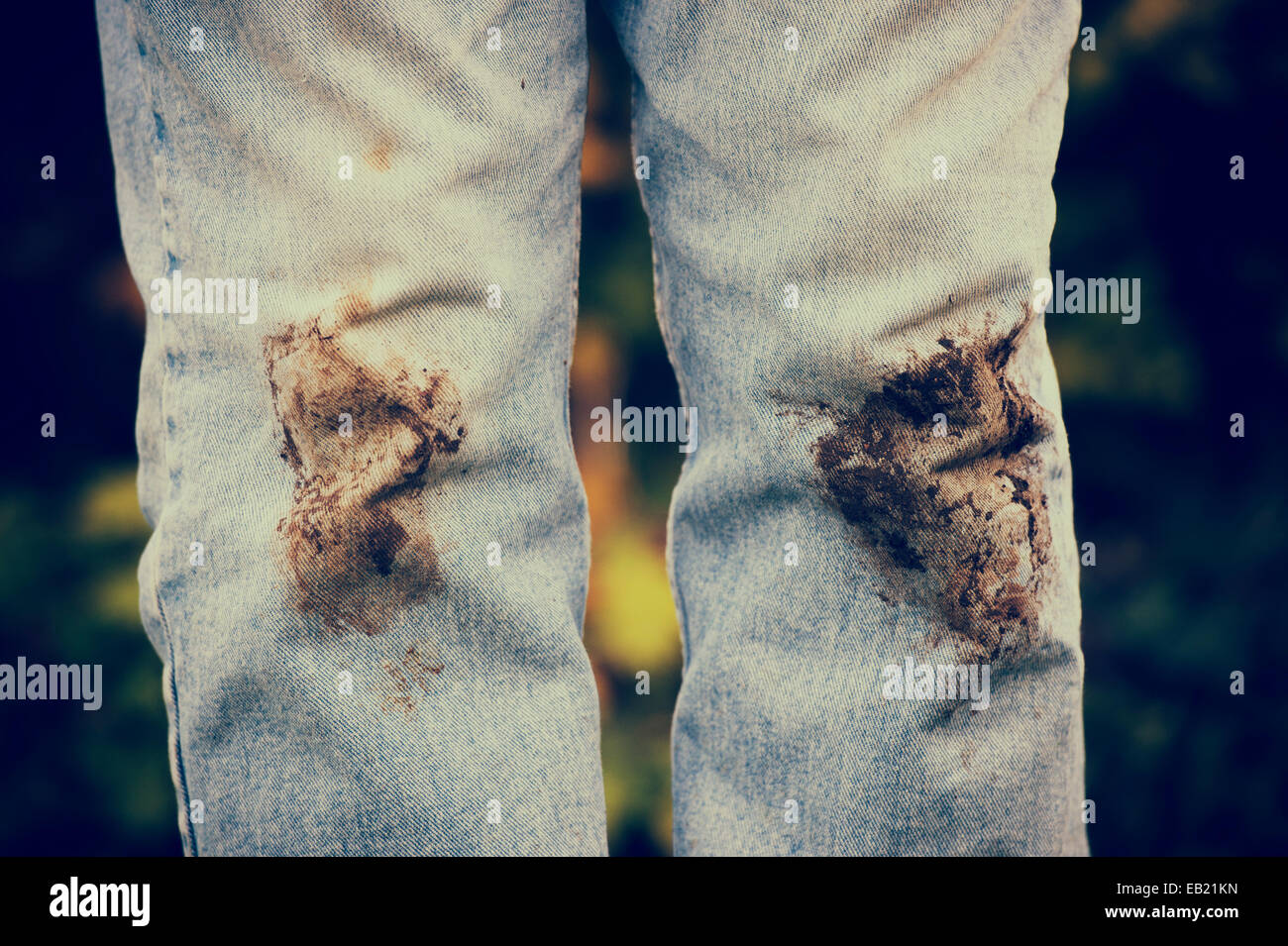 Muddy knees on jeans. Vintage style Stock Photo