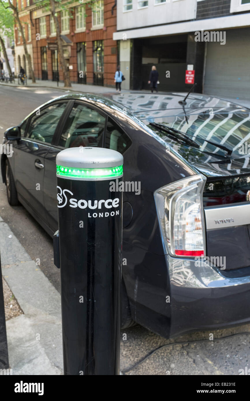 Toyota Prius being charged at a 'Source London' street charging point. Stock Photo