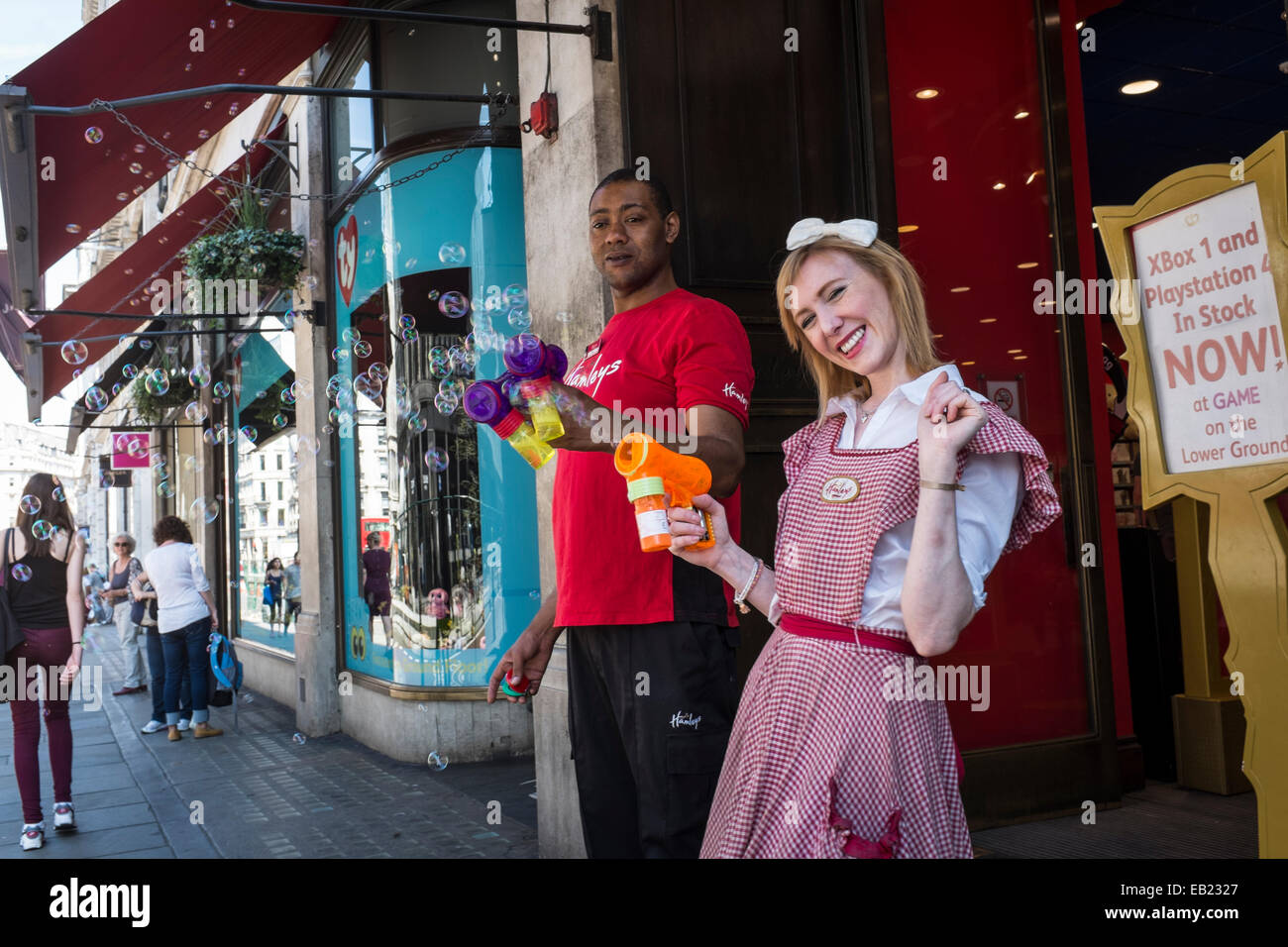 Hamleys Toy Shop staff demonstrate bubble machines toys to passing shoppers. Stock Photo