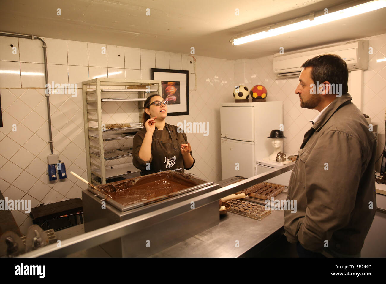 woman talking customer inside chocolate store europe Stock Photo