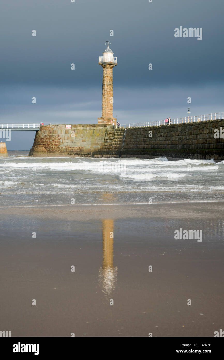 Whitby West Pier arm and lighthouse Stock Photo