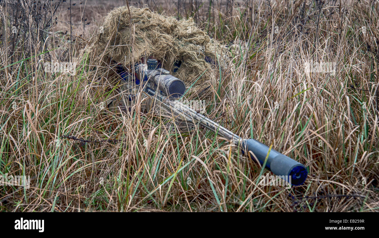 British sniper with his L115A3 long range sniper rifle on exercise in Poland nov 2014 Stock Photo