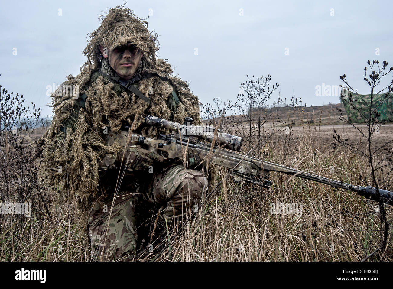 British sniper with his L115A3 long range sniper rifle on exercise in Poland nov 2014 Stock Photo