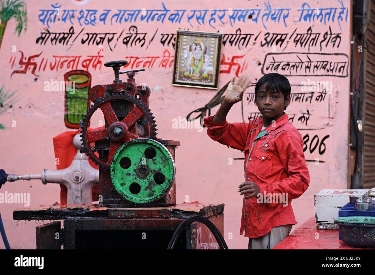 Young Indian boy cleaning a sugarcane juice machine India Stock Photo