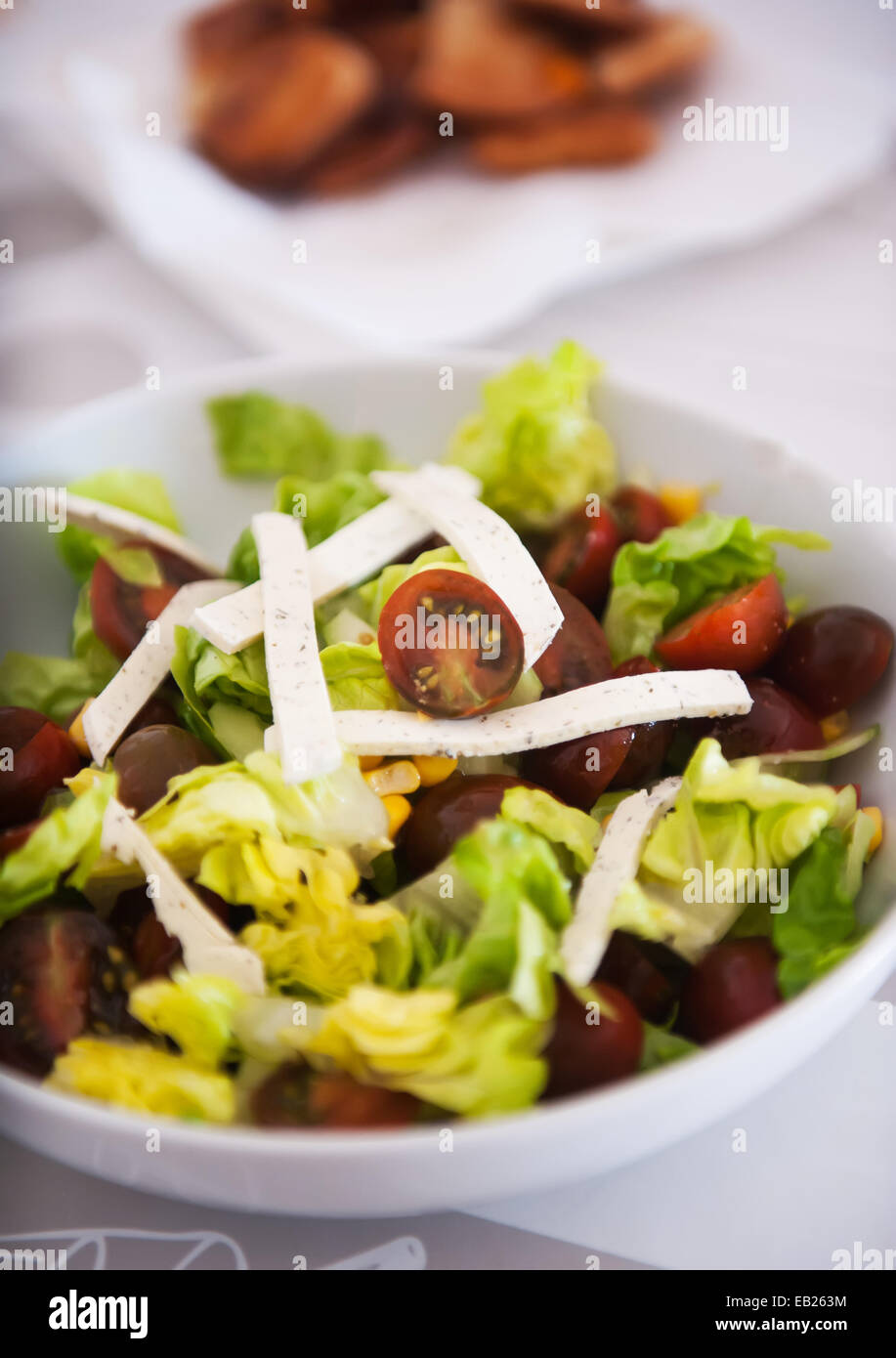 Salad with lettuce, cherry tomatoes and cheese with diced Stock Photo