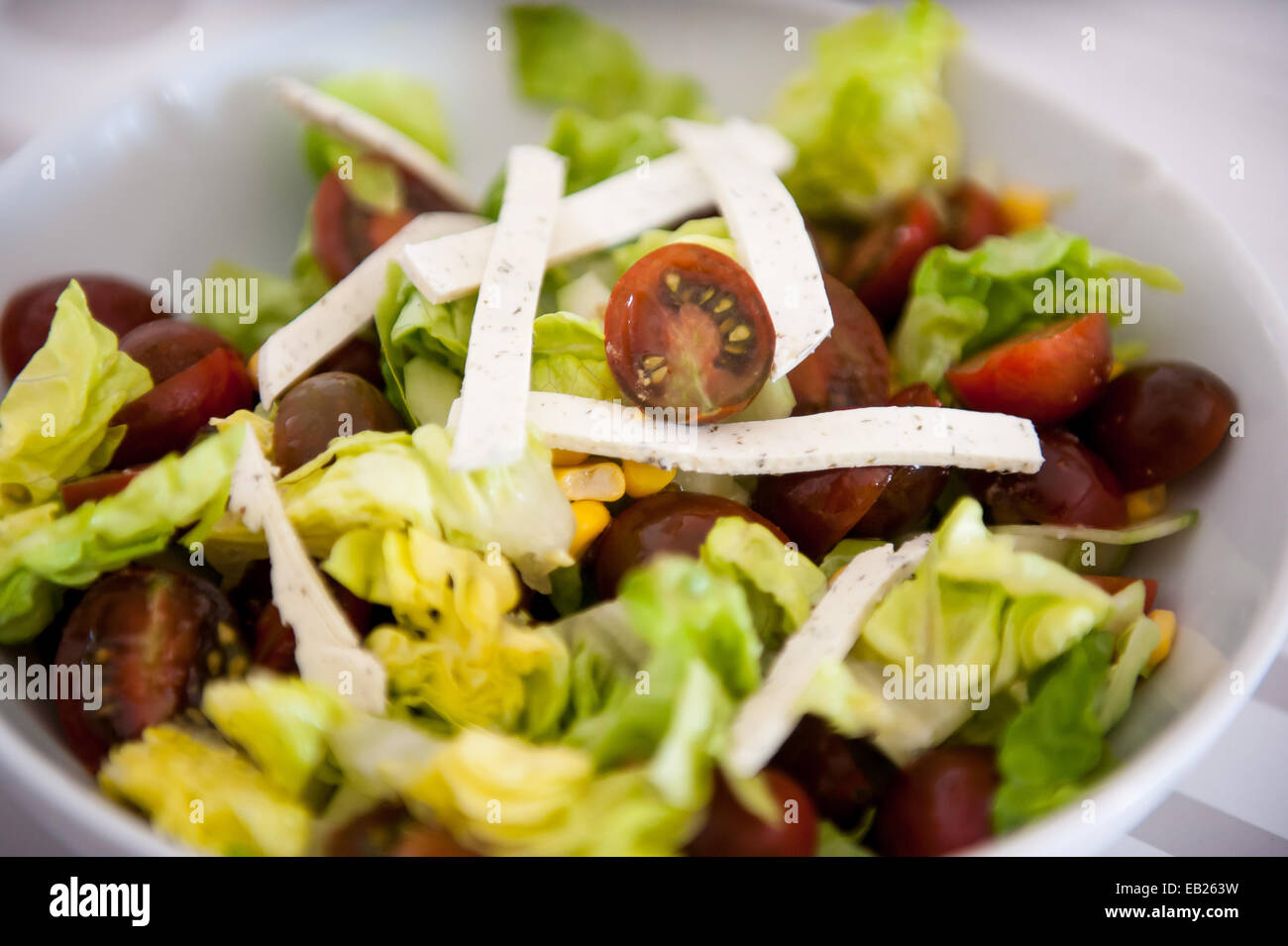 Salad with lettuce, cherry tomatoes and cheese with diced Stock Photo