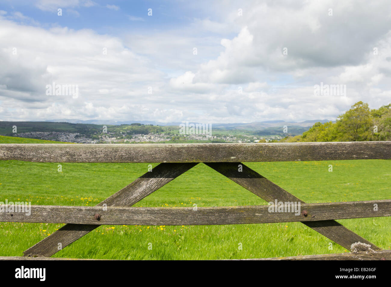Five barred field gate and meadow overlooking the town of Kendal in England's Lake District Stock Photo