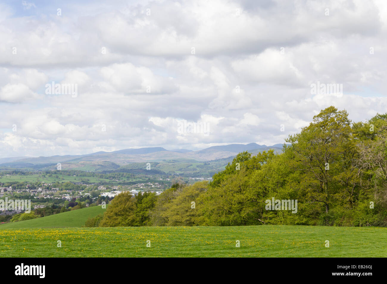 Kendal's northern fringe and western lake District landscape, viewing west-north-west to the Fells beyond Lake Windermere. Stock Photo