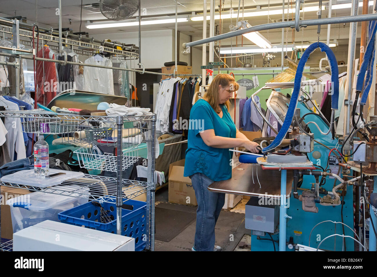 Broomfield, Colorado - A worker at Lionheart Cleaners, a laundry and dry cleaning firm. Stock Photo