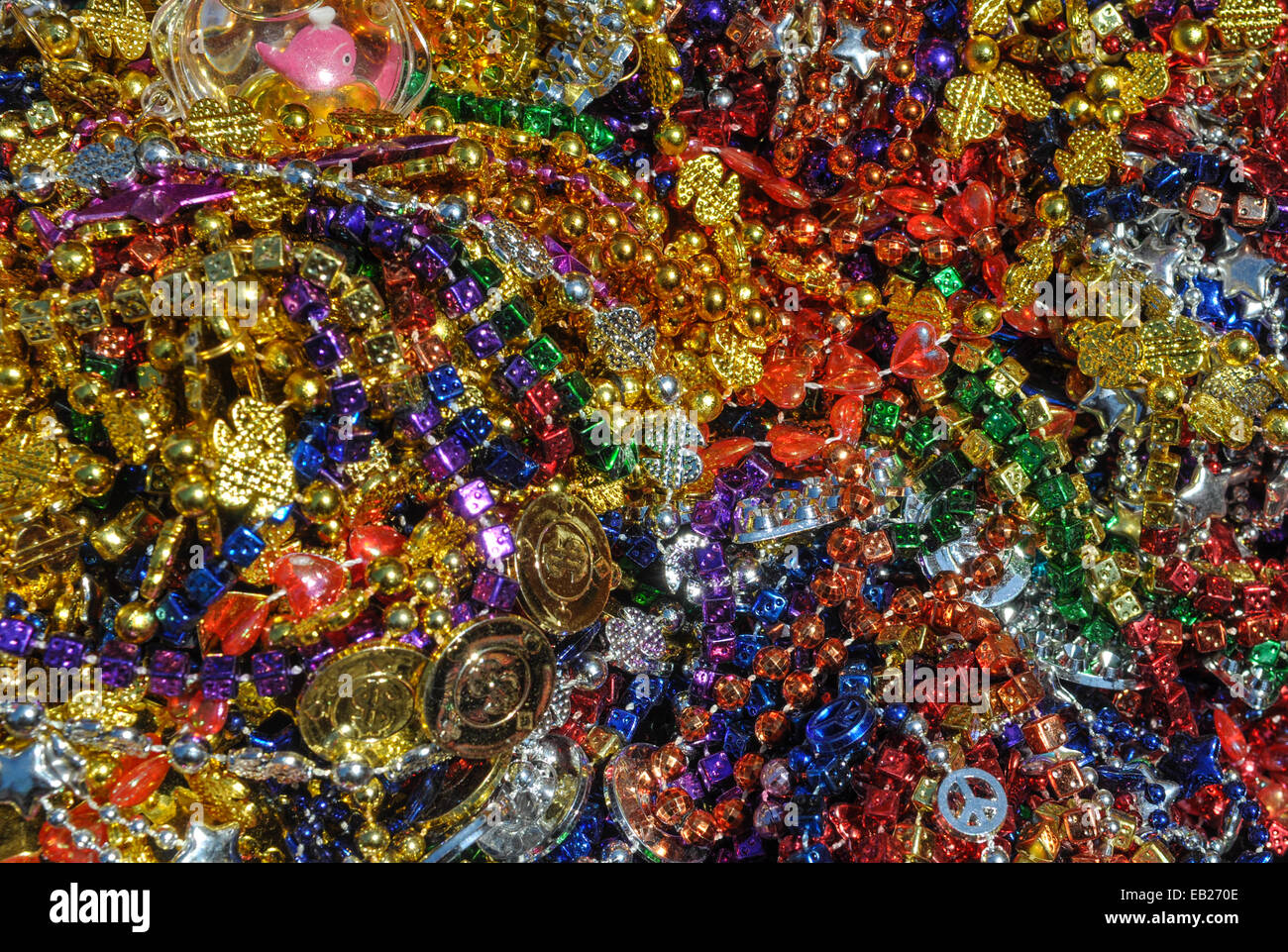 Background made up of mulit-colored including gold, purple, blue, green and pink mardi gras beads Stock Photo